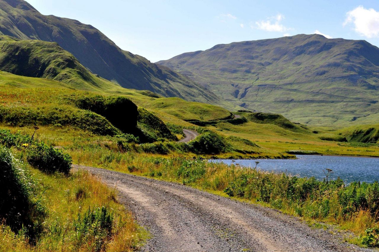 A gravel road leading into the mountains of Unalaska Island Photo