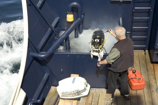 MV Tiglax engineer working on skiff motor Picture