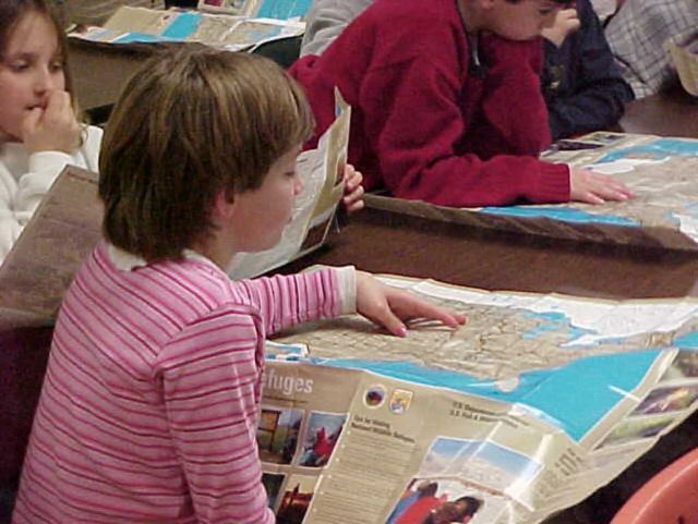 Girl Reads Refuge Visitor's Guide Picture