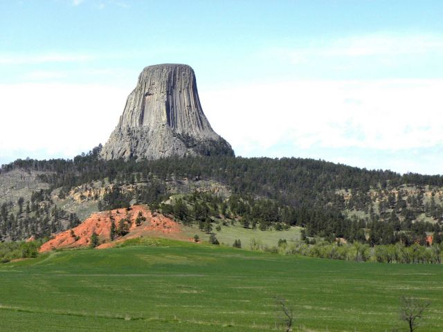 Devils Tower seen above an irrigated field Picture