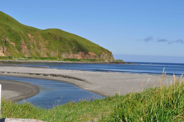 A stream winding its way to a beach on the Bering Sea. Picture