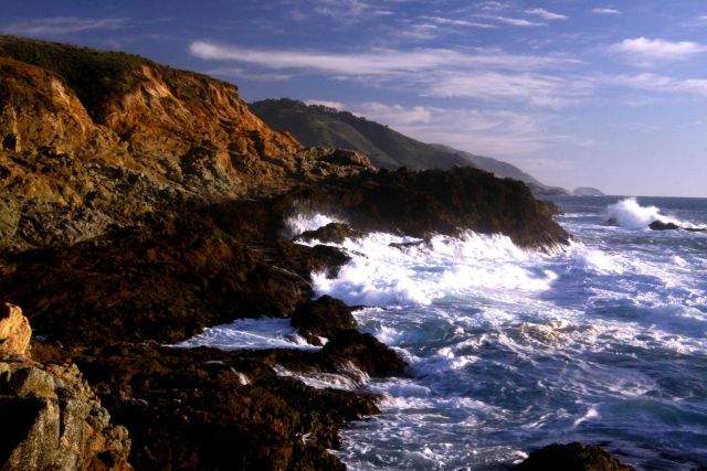 A wave breaking against the rocks of the Granite Canyon area along the Big Sur coastline Picture