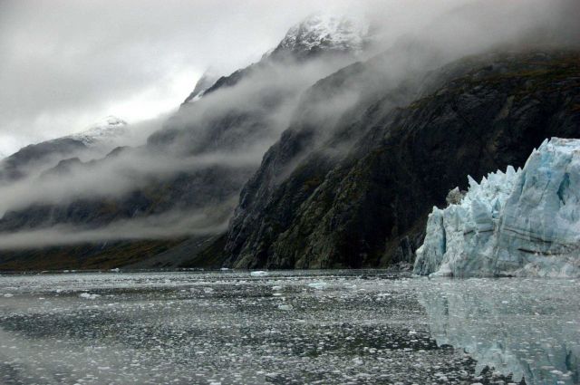 The incomparable scenery of Tarr Inlet - steep-sided fjord, wisps of clouds, a reflecting glacier. Picture