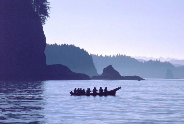 A crew in a traditional Northwest Canoe approaches the Hoh River on the Olympic Peninsula in Washington Picture