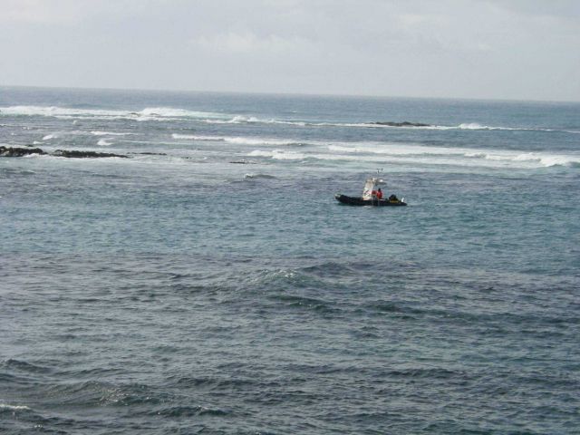 Zodiac pikcing its way through rocky ledges returning from mapping work at low tide. Picture