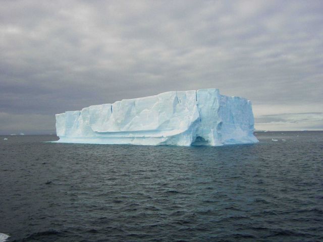 A small tabular iceberg with an ice cave Picture