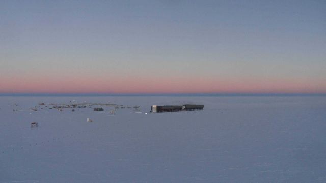 The pink haze of a long twilight at South Pole Station. Picture