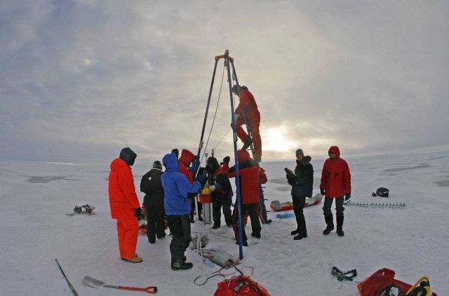 Science team deploying DAMOCLES (Developing Arctic Modeling and Observing Capabilities for Long-term Environmental Studies) system through ice Picture