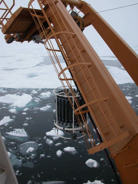 A CTD cast and rosette full of water sampling containers are lowered into icy Arctic waters during the NOAA-sponsored cruise to study marine life in t Picture