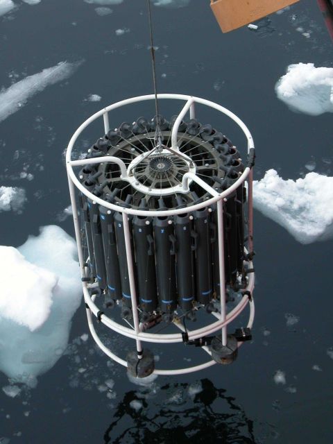 A CTD cast and rosette full of water sampling containers are lowered into icy Arctic waters during the NOAA-sponsored cruise to study marine life in t Picture