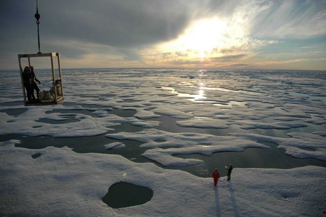 Scientists descending to the ice below from the manlift on the U.S Picture