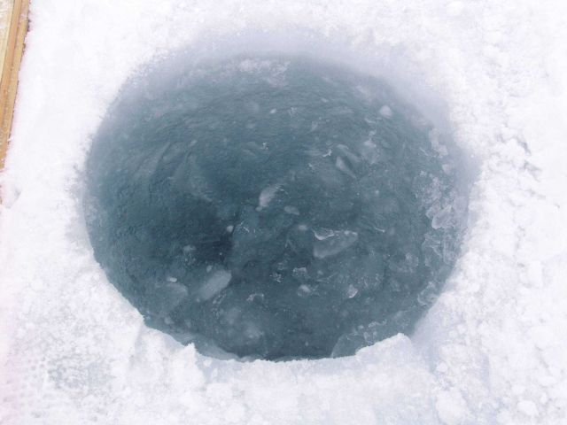 Hole cut through ice for SCUBA diving operations. Picture