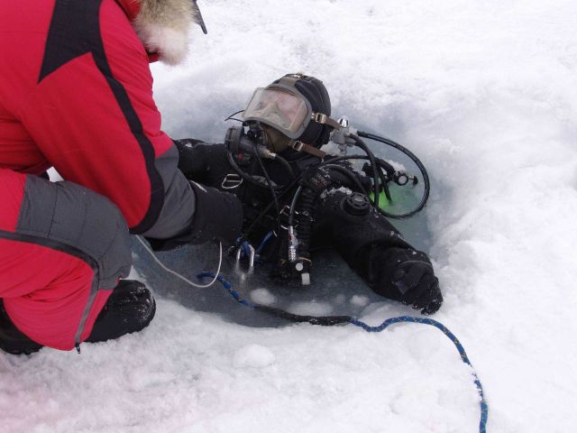 Ice diver at egress hole. Picture