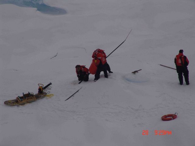 Placing ice and water temperature sensor in prepared hole in ice flow Picture