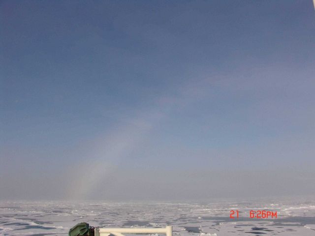 Portion of halo formed by sun refracting through ice crystals in atmosphere. Picture