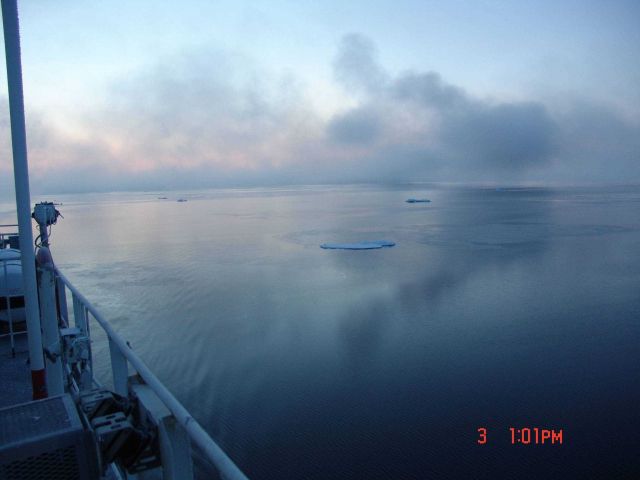 Reflections on grease ice with a few small floes. Picture