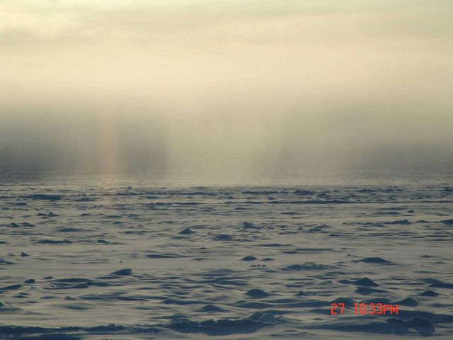 A snow shower as seen over a hummocky ice landscape. Picture