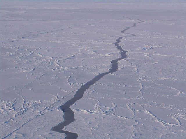 Long lineal fractures through a mix of old hummocky ice and first-year smooth ice. Picture