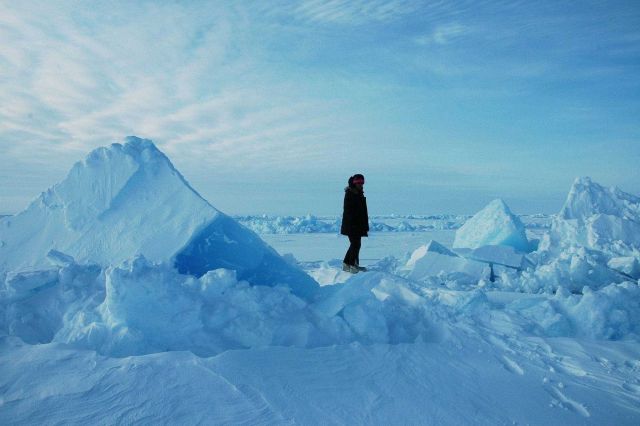 Huge blocks of ice forming a pressure ridge with scientist providing scale of features. Picture