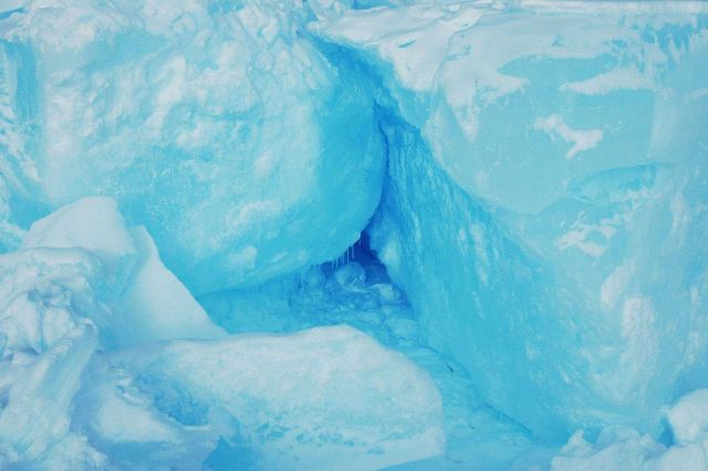 Huge blocks of ice forming a pressure ridge with icicles formed from melting probably caused by sun heating ice and causing localized melting and refr Picture