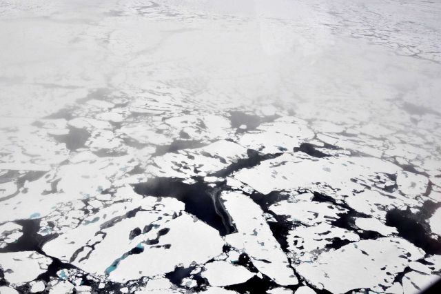 Helicopter eye view of ice floes, melt ponds, areas of brash ice, and other phenomena. Picture