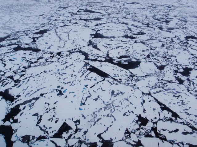 Helicopter eye view of ice floes, melt ponds, areas of brash ice, and other phenomena. Picture