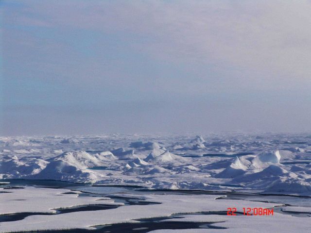 Looking toward hummocky multi-year ice contrasted with smoother newer ice in the foreground. Picture
