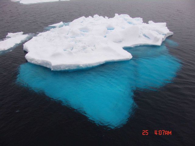 A large aquamarine keel is apparent on the edge of a multi-year ice floe. Picture