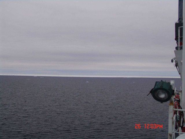 A large area of open water with the ice pack in the distance. Picture