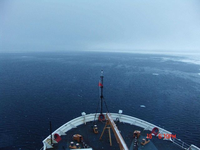 Looking over the bow of the USCGS HEALY at a stretch of open water on which frazil and nilas ice are forming Picture