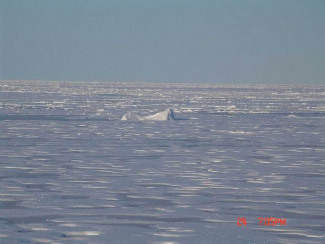 Multi-year ice with refrozen melt pools and relatively large berg-like chunk of ice frozen into floes. Picture