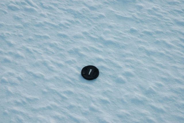 Camera lens camp showing scale of mini-hummocks on ice surface at Ice Camp. Picture