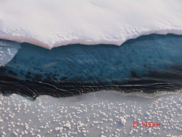 Graupel covering ice surface in vicinity of crack in pack ice. Picture