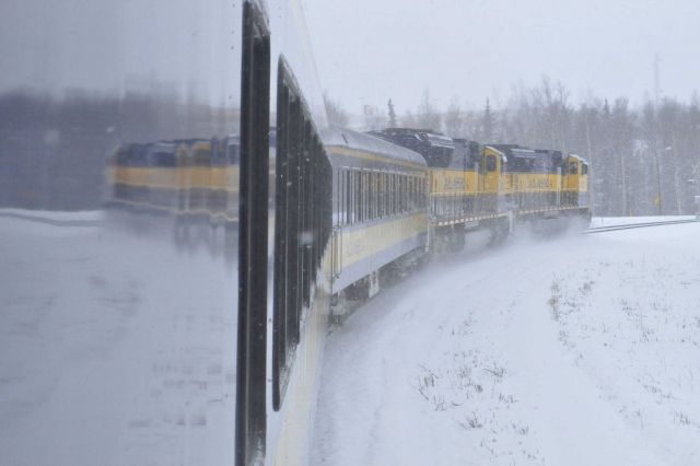 Running through a snow squall along the Alaska Railroad Aurora Winter Train. Picture