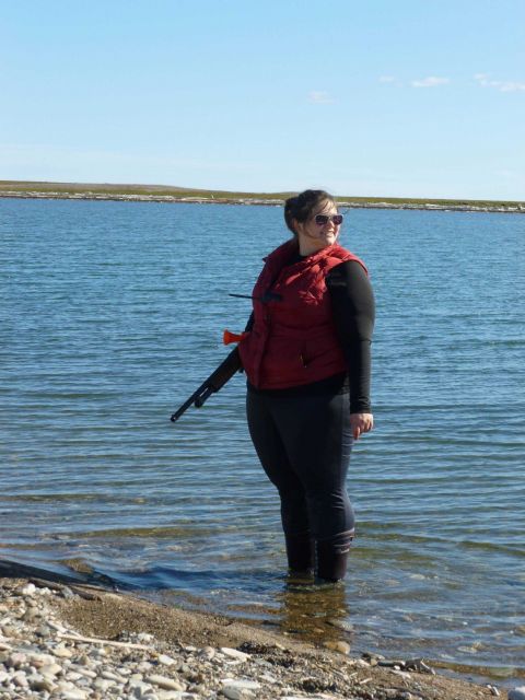 Chief Survey Tech Tami Beduhn standing bear watch at Demarcation Point. Picture