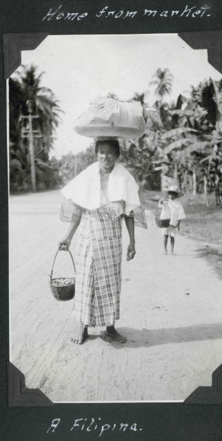 Home from market, a Filipina lady balancing her load. Picture