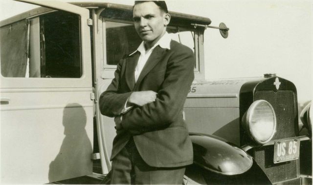 Roy Sylar, truck driver and umbrella holder for the airplane beacon party of George L Picture
