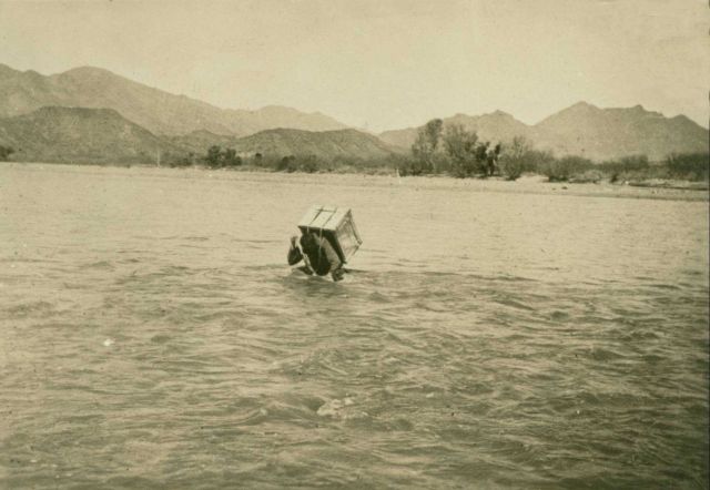 Packing a theodolite across the swollen Verde River, 1924. Picture