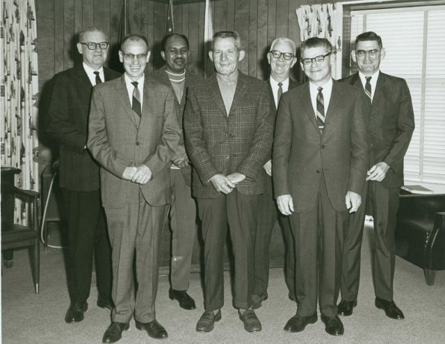 Smiling Coast Surveyors in the Director's Office of the C&GS Atlantic Marine Center. Picture