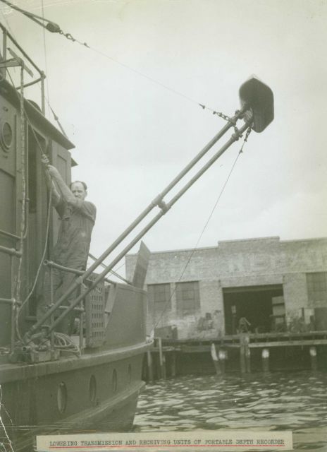Lowering transducer of portable 808 Fathometer system. Picture