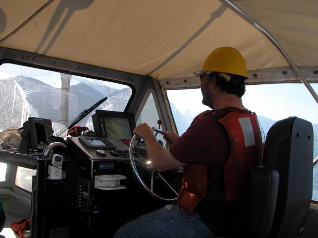 Coxswain of launch off NOAA Ship RAINIER keeping the boat on line while operating in SE Alaska. Picture