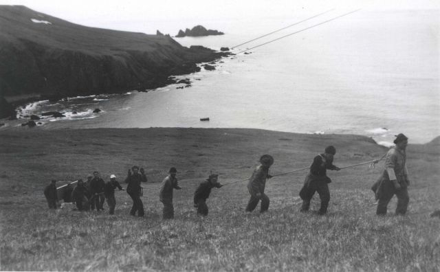 Pulling Shoran Station equipment and supplies up Cape Wrangell Peak during the installation of the first electronic navigation which used Shoran Picture