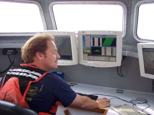 Survey technician operating survey system on launch Picture