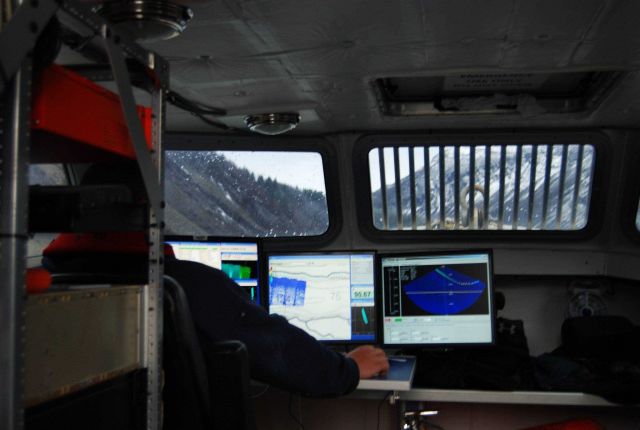 Survey system display showing data logging display on left; real-time multi-beam depth display in center, and right is multi-beam pattern showing bott Picture