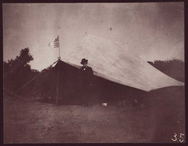 George Davidson standing outside a field tent somewhere in California. Picture