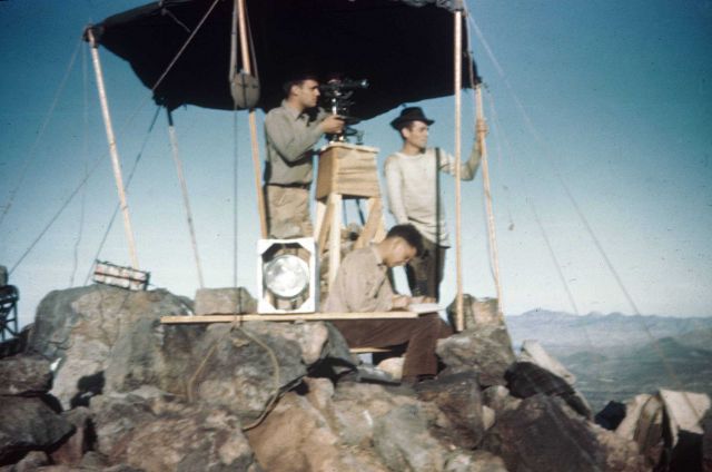 Bob Green, Hadley, and Reitinger observing angles from a mountain peak. Picture