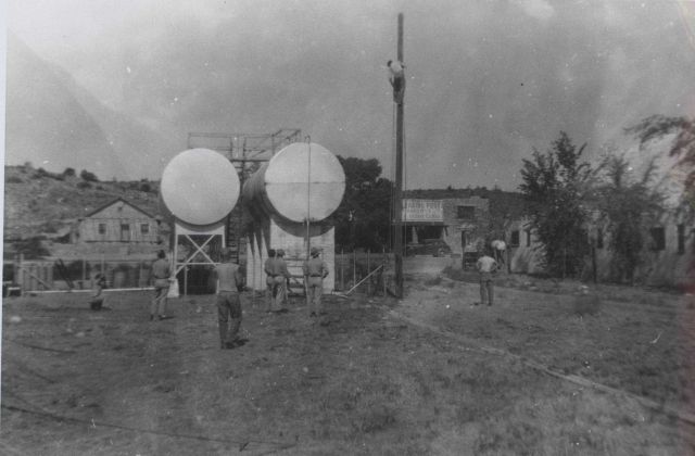 Putting up the pole for electrical wiring at the camp at Peach Springs. Picture