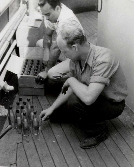 Preparing drift bottles for launching from USC&GS Ship EXPLORER. Picture