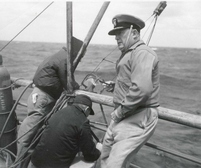 Captain Crosby, Chief of the Tides and Currents Division of the USC&GS, looks on as Roberts Radio Current Meter is deployed Picture