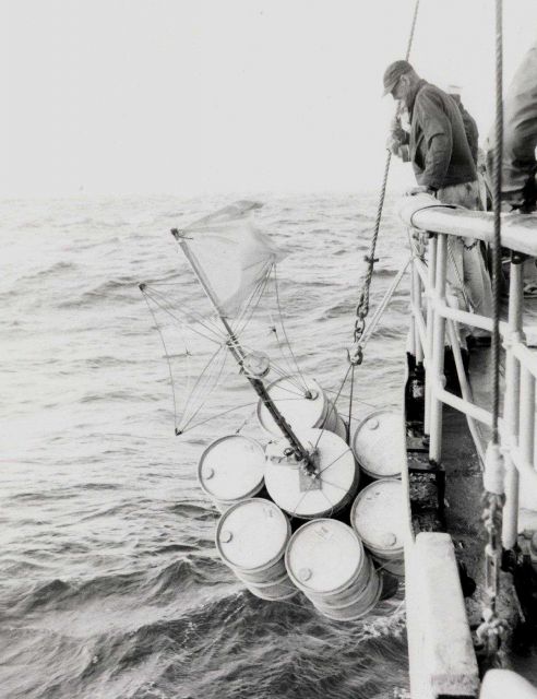 Placing marker buoys in water, purpose not noted on photograph. Picture